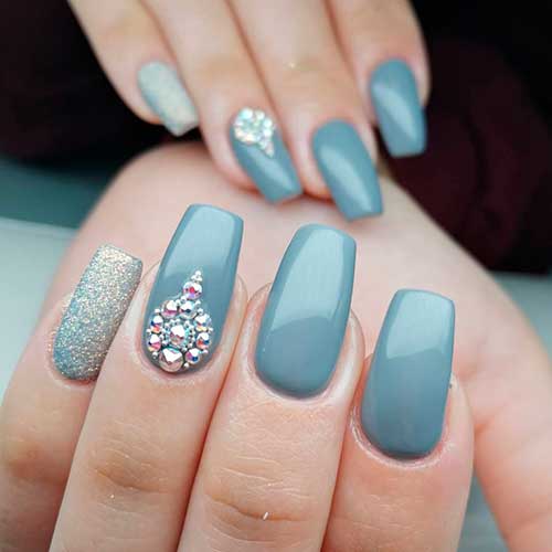 Cute gray coffin nails with glitter accent nail and rhinestones!