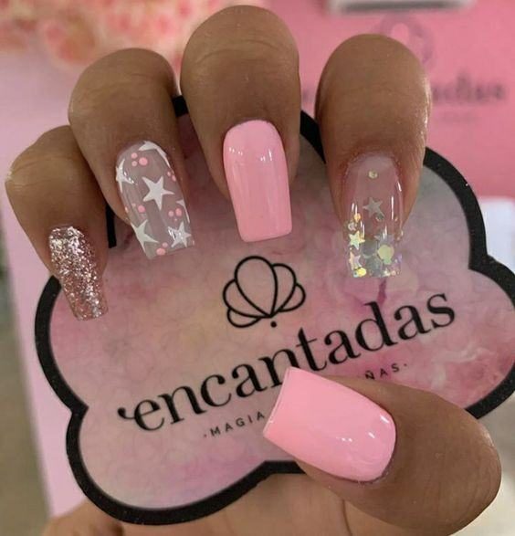 100 Nails with stars nude enamel stars and sparkles on the index and ring fingers pink enamel on the middle fingers and metallic frosted thumb on the little finger